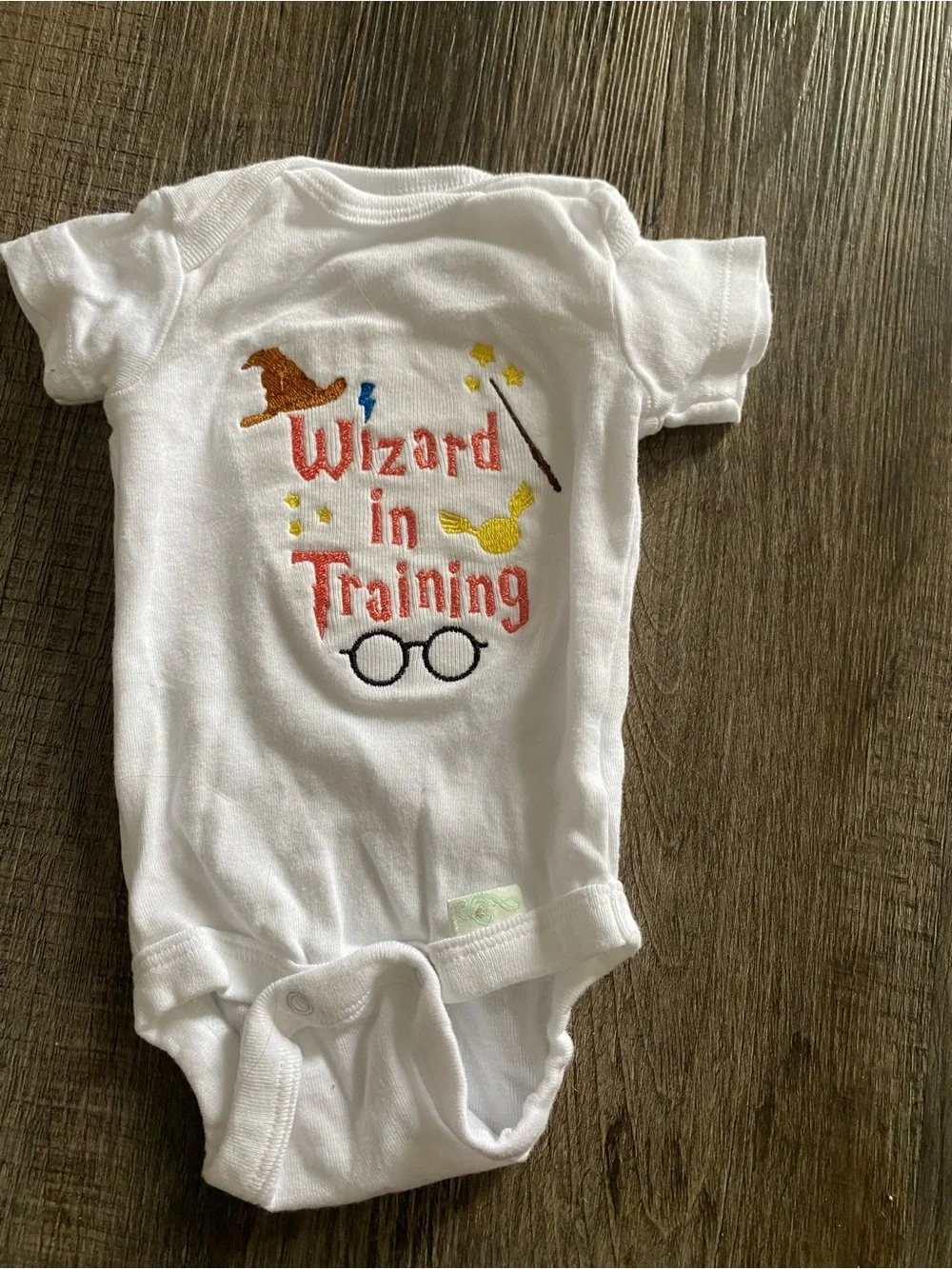 Home embroidered baby bodysuits